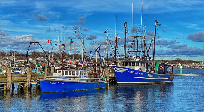 Two Blue Fishing Boats In Provincetown Harbor On Cape Cod.
